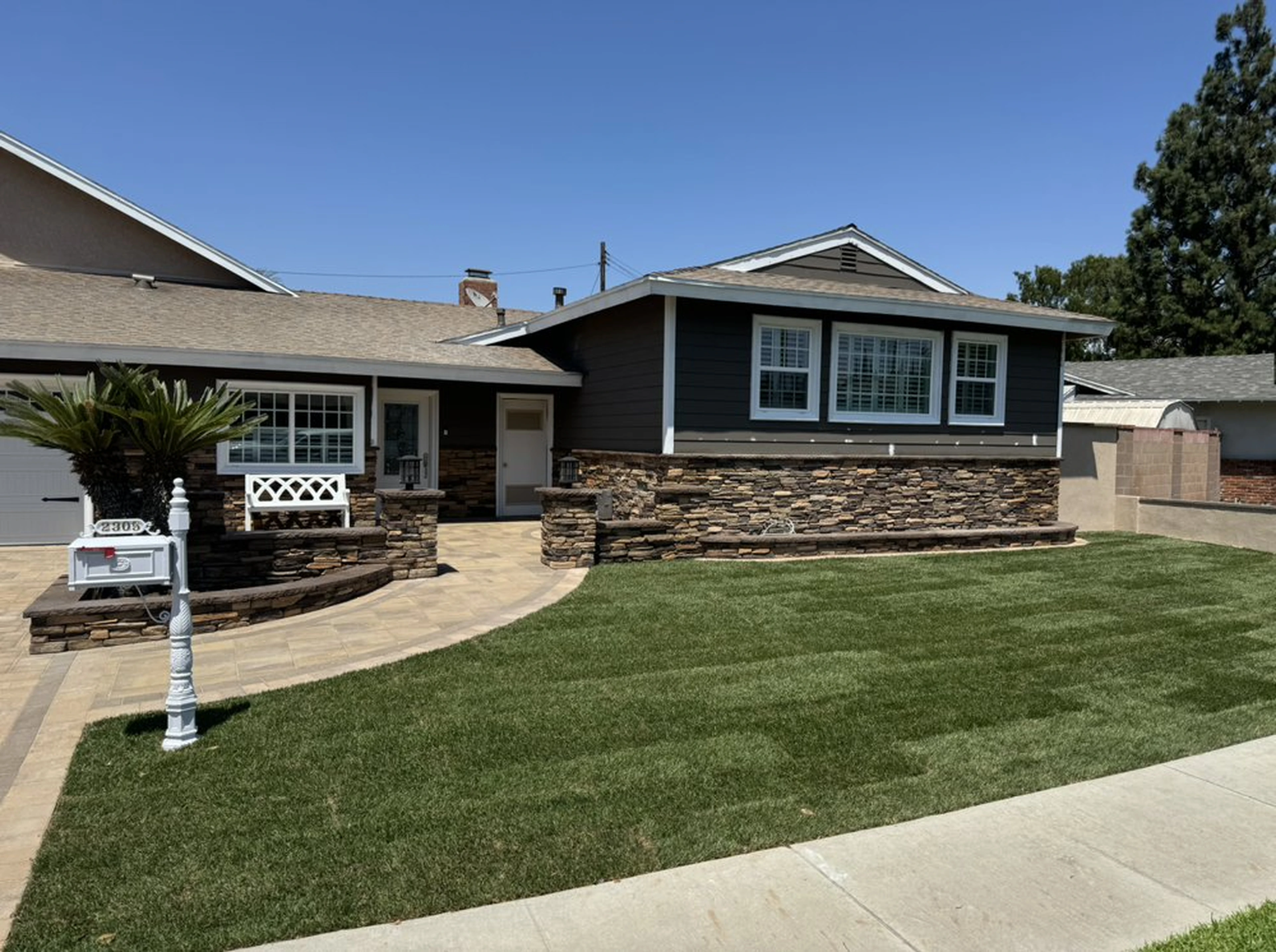 Completed Anaheim front yard with lawn, masonry accents, hardscape, and upgraded exterior landscaping